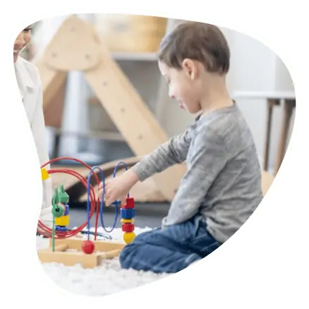 cot-os-f2 young boy playing with toys in kids OT session